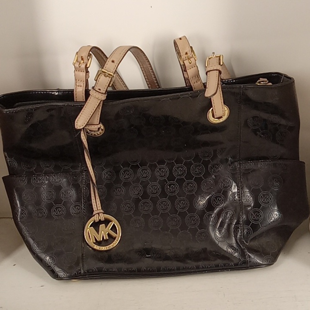 Micheal Kors black purse With?Three Pockets in the inside one small zipper pocke
